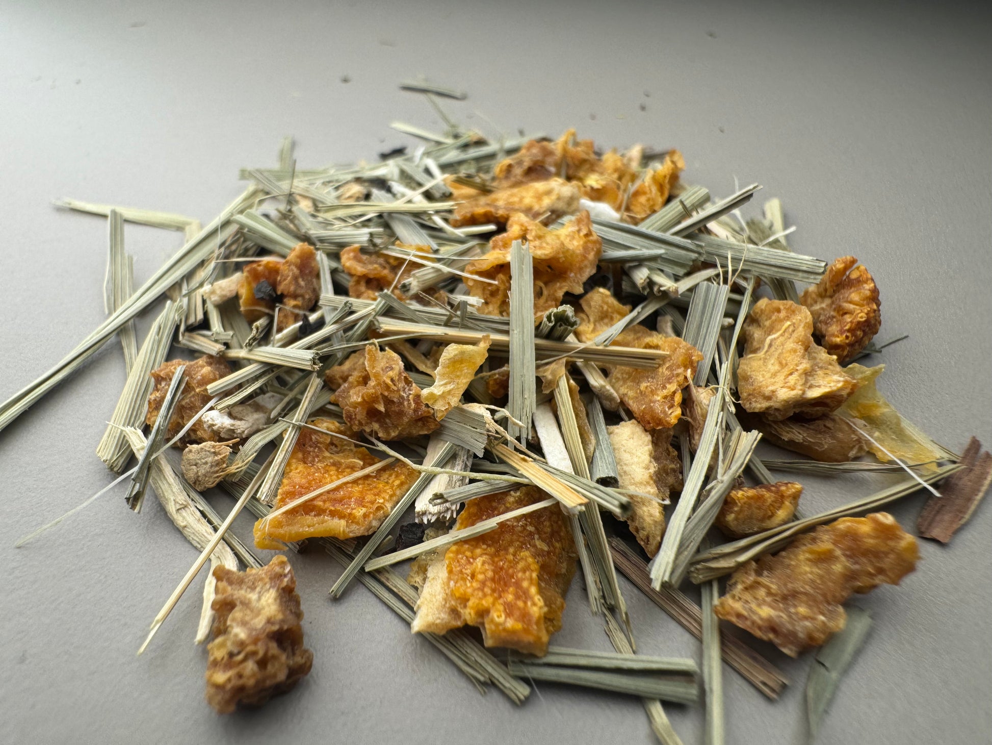 Mixture of dried herbs and plants on a gray surface